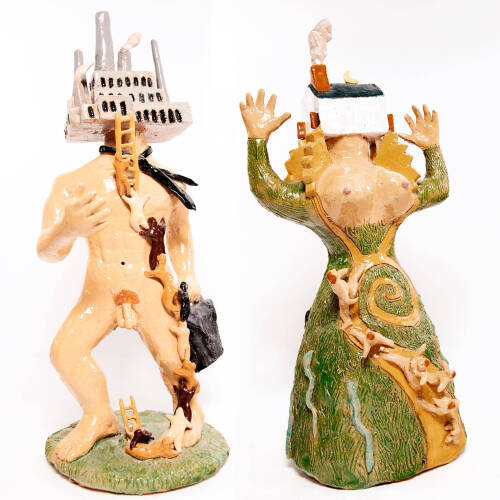 Two ceramic figurines, one looks like a nude man with a factory for a head. He carries a briefcase. The other looks female and with a house for a head.